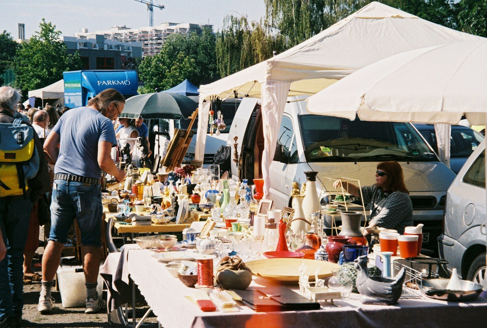 a group of people standing around a table covered in bottles